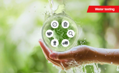 Hand holding large droplet of water testing solutions