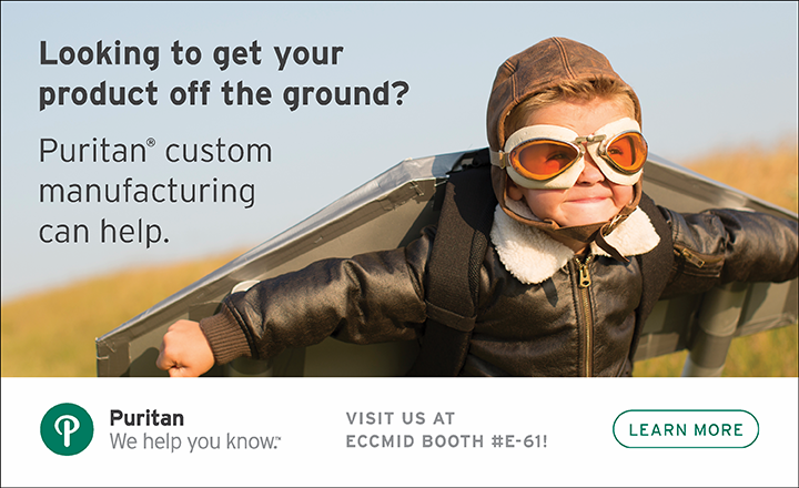 Child playing at dress up with aviator goggles and wings